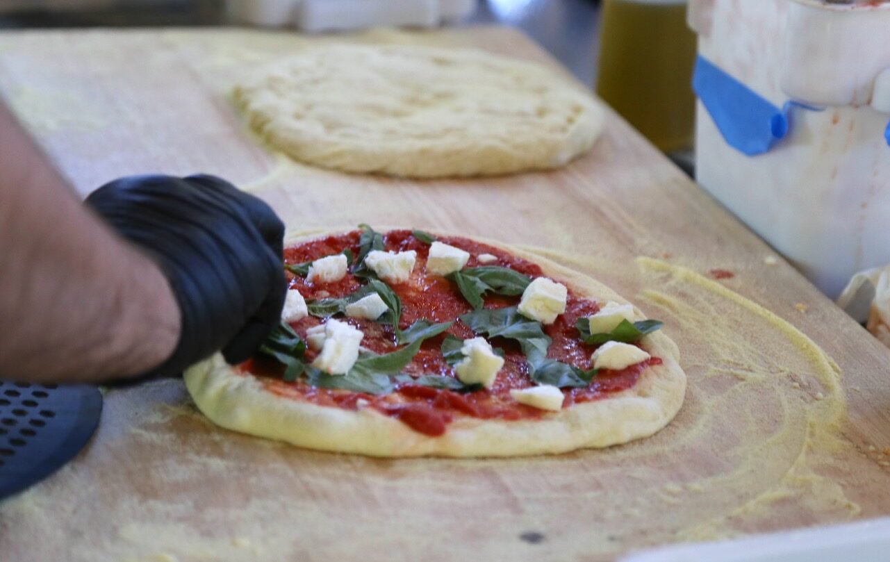 Hand-stretching the dough